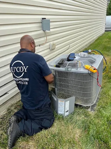 HVAC technician services an AC unit in DMV, showcasing Washington DC Homepage services for reliable home comfort and system maintenance.