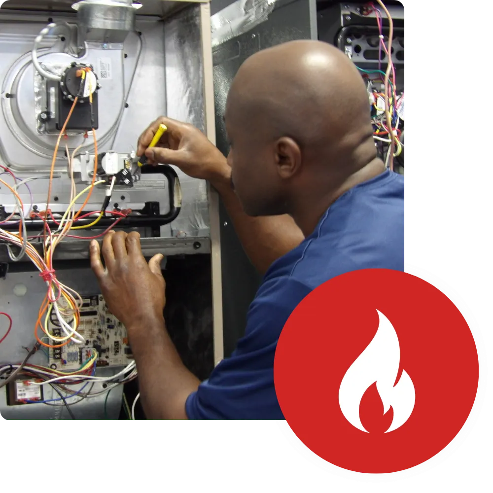HVAC technician repairs a furnace as part of the Main Homepage services. He uses a screwdriver on the furnace's electrical components.