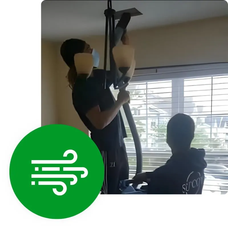 Main Homepage: Two professionals cleaning a chandelier with specialized equipment, ensuring a spotless shine in a bright, airy space.